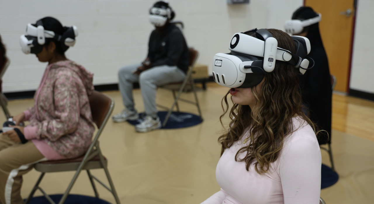 A group of students wear virtual reality headsets